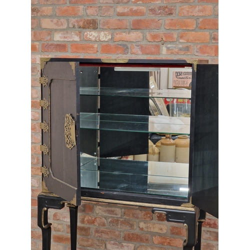 1384 - 20th century Chinese ebonised cabinet on stand with gilt metal mounts and mirrored shelved interior,... 