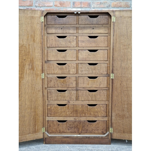 1419 - 20th century oak double door cabinet / bank of drawers fitted with an arrangement of sixteen drawers... 