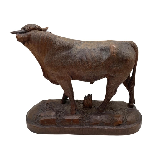 445 - Expertly carved Black Forest standing bull, on a naturalistic base, 17 x 18cm