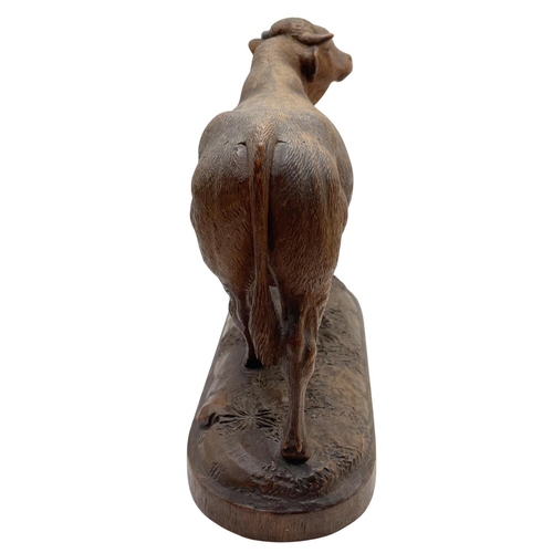 445 - Expertly carved Black Forest standing bull, on a naturalistic base, 17 x 18cm