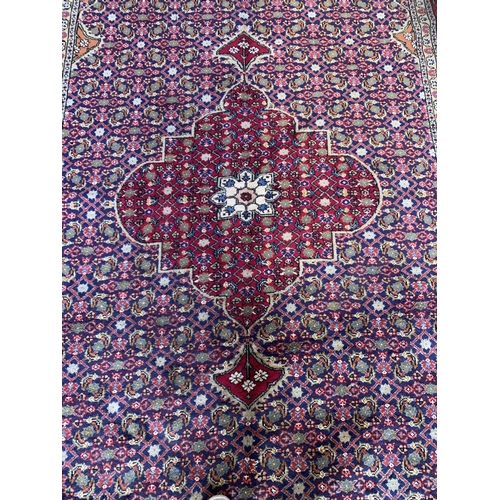 1728 - Good quality Sarouk rug, with intricate floral design, red ground, 300cm x 195