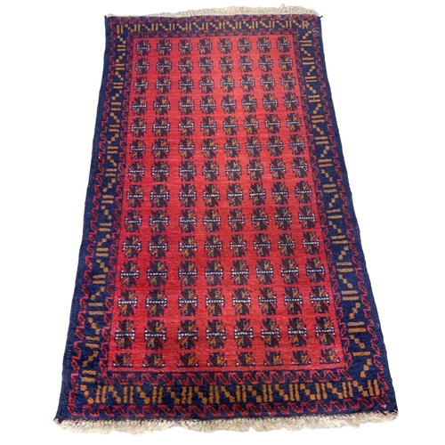 1738 - Baluchi village rug, geometric design, red ground 145cm x 85cm