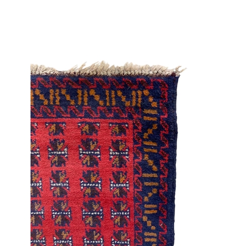 1738 - Baluchi village rug, geometric design, red ground 145cm x 85cm