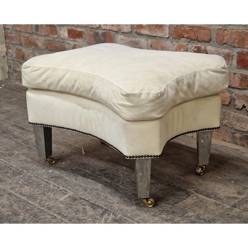 1308 - Contemporary armchair and footstool with studded upholstery raised on brass castors, H 108cm x W 88c... 