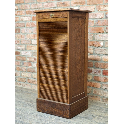 1426 - French oak tambour fronted filing cabinet, the fall front with lock and key enclosing a shelved inte... 