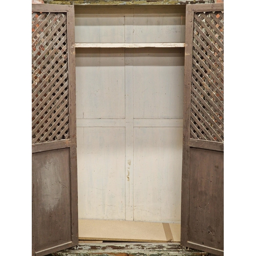 1428 - 18th century Spanish cupboard, with original paint, lattice panel doors enclosing a shelved interior... 