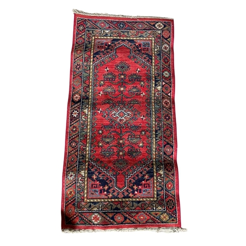 1757 - Kurdish runner, floral medallion, red ground, 140cm x 70cm