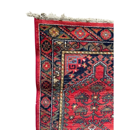 1757 - Kurdish runner, floral medallion, red ground, 140cm x 70cm