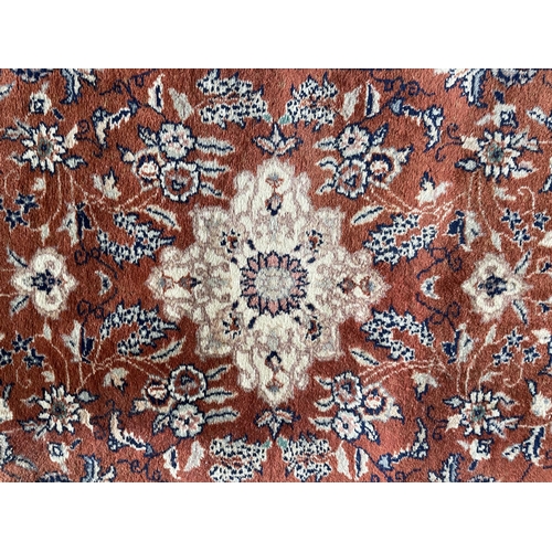 1758 - Keshan rug, floral design, burnt red ground, 125cm x 70cm