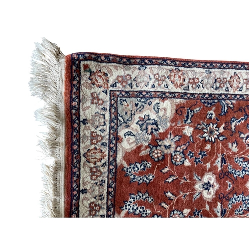 1758 - Keshan rug, floral design, burnt red ground, 125cm x 70cm