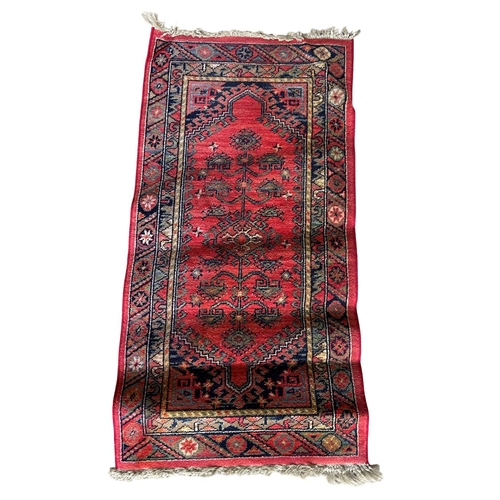 1759 - Kurdish runner, floral medallion, red ground, 130cm x 70cm