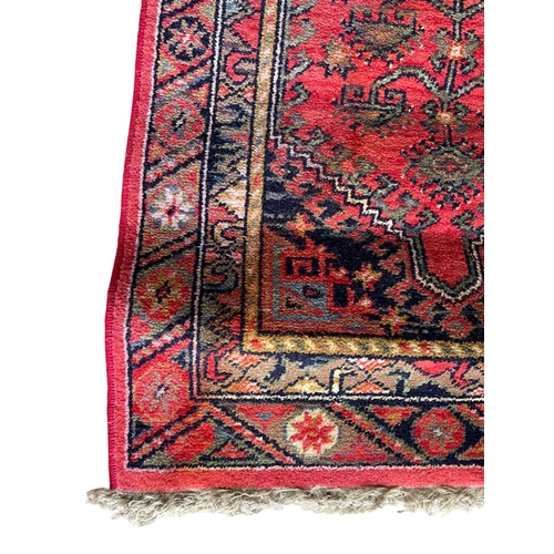 1759 - Kurdish runner, floral medallion, red ground, 130cm x 70cm