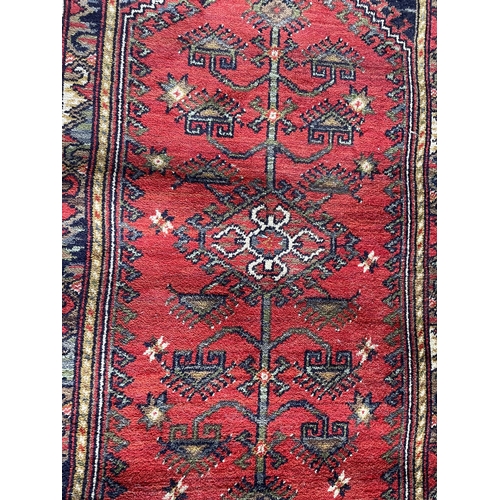 1762 - Kurdish runner, floral medallion, red ground,  70cm x 90cm