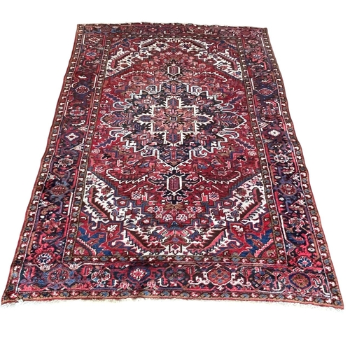 1764 - Good Persian Heriz carpet, blue floral design on red ground, 310cm x 220cm