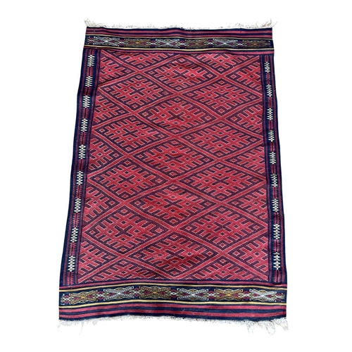 1771 - Good quality Sumak rug, geometric medallion design, red ground, 165cm x 120cm