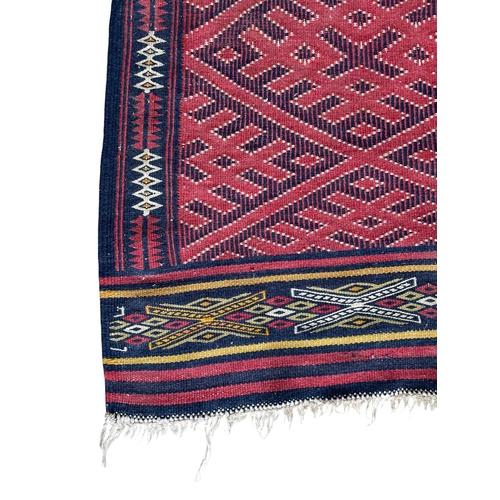 1771 - Good quality Sumak rug, geometric medallion design, red ground, 165cm x 120cm