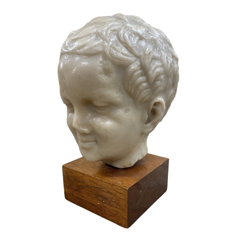 1439 - Hand carved wax head sculpture of young boy, having indistinct mark to verso, likely the artists fir... 