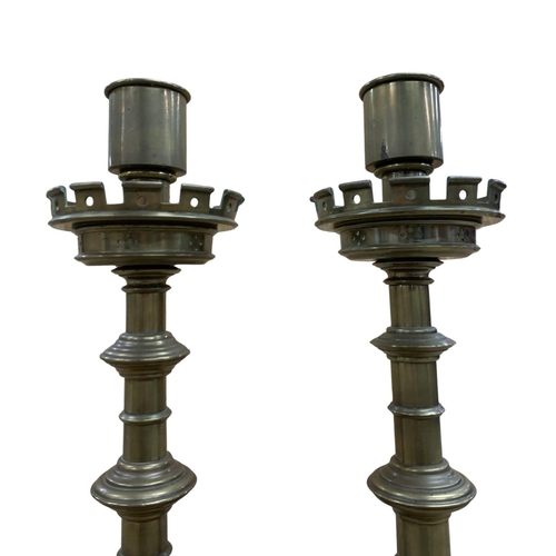 1068 - Pair of brass Ecclesiastical style alter pricket candlesticks, having stepped circular base with pie... 