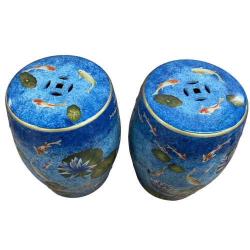 301 - Pair of Chinese pierced top porcelain garden stools having Koi carp and waterlilies pattern atop mot... 