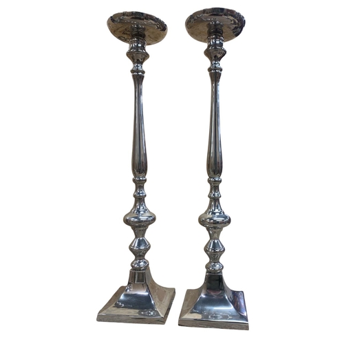 1094 - Kenneth Turner of London - A pair of leather and silver plated candlesticks, together with a larger ... 