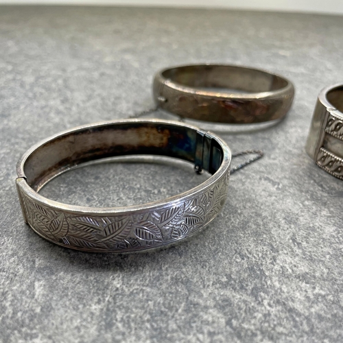 31 - Good quality silver hinged bangle by Robert James Dick, another by Frank William Cole and a third by... 