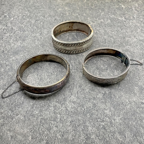 31 - Good quality silver hinged bangle by Robert James Dick, another by Frank William Cole and a third by... 