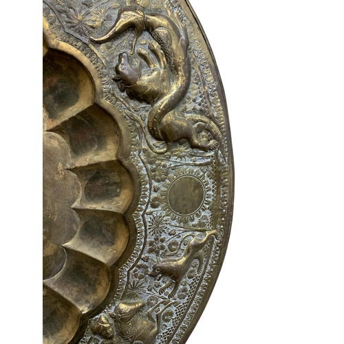 335 - Antique Eastern brass brazier or charger, embossed with beasts and hunting scenes, 71cm diameter