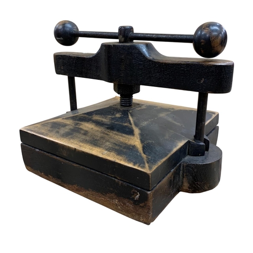 490 - Small desktop book press, having a stained wood finish with the twist handle having ball finial deco... 