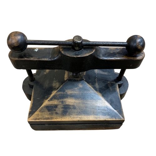 490 - Small desktop book press, having a stained wood finish with the twist handle having ball finial deco... 