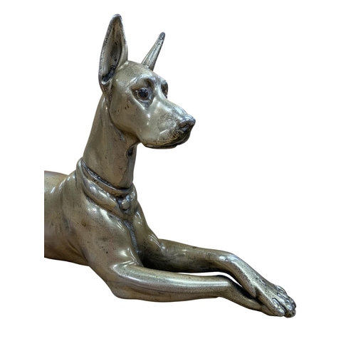 538 - Recumbent silver plated Great Dane, having glass inset eyes, heavily worn down to nickel base, L 30c... 