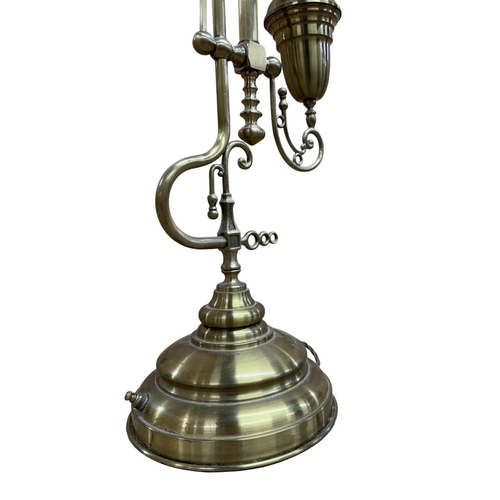 1069 - Decorative brass table lamp, with stepped circular base having ornate scrolled finial frame with ori... 