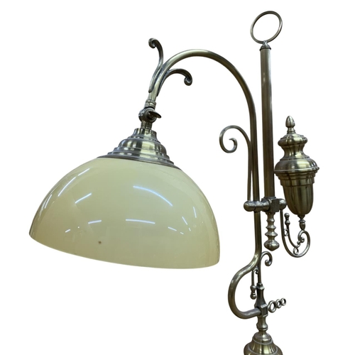 1069 - Decorative brass table lamp, with stepped circular base having ornate scrolled finial frame with ori... 