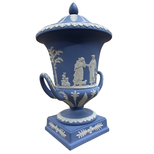 409 - Wedgwood blue jasperware twin handled Campana urn and cover with classical relief decoration ,H 30cm