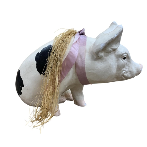 609 - Large plaster butchers shop display styled piggy bank in the form of a sitting pig with ribbon and s... 