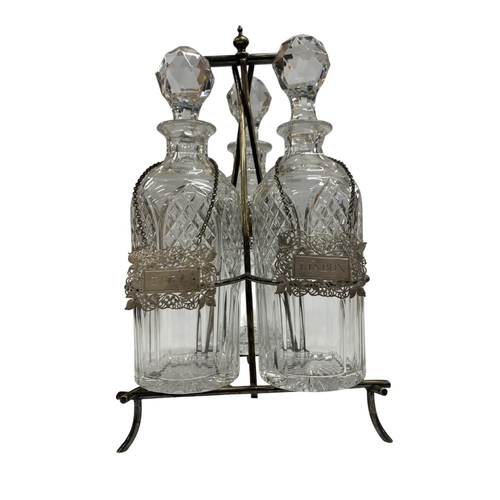 131 - In the manner of Christopher Dresser, silver plated Aesthetic Movement bottle stand, having three cu... 