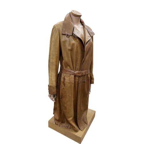 619 - Female mannequin atop wooden plinth base, holding vintage brown leather coat, H 125cm