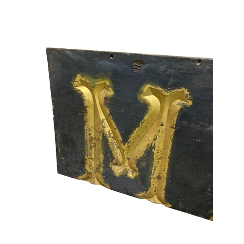 1022 - ' MAY ' large painted wooden wall sign with carved gilt lettering, H 56cm x W 166cm