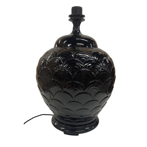 1113 - Black ceramic table lamp with repeating scale-type design raised on a hardwood base, 45cm high, toge... 