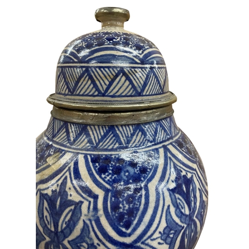 441 - Moroccan blue and white lidded urn vase with underglaze repeating cartouche decoration and geometric... 