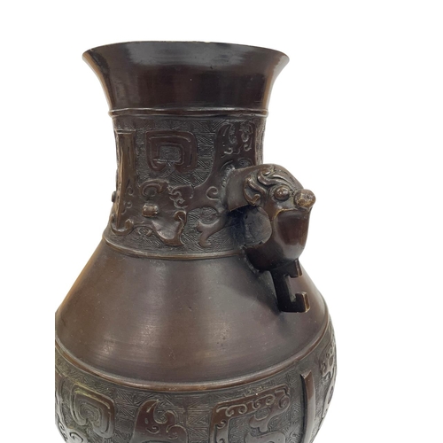 350 - Chinese 19th century archaistic bronze double handled 'hu' vase, with twin handles modelled as mythi... 