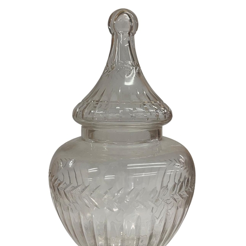 427 - Large Regency styled cut glass bon bon sweet jar, having stepped square base with urn form body hold... 