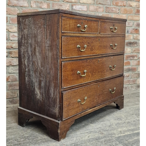 1253 - Georgian oak chest of two short over three long graduated drawers with brass handles, raised on brac... 