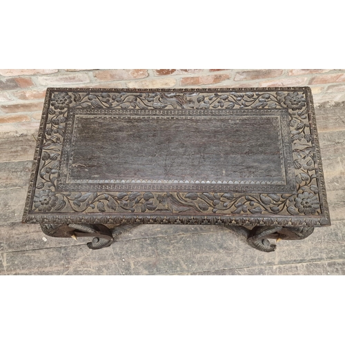 1305 - Anglo Indian carved hardwood side table with elephant supports, H 77cm x W 76cm x D 40cm