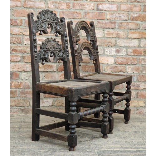 1325 - Two similar 17th century carved oak hall chairs with solid seats, H 103cm x W 49cm x D 41cm (2)