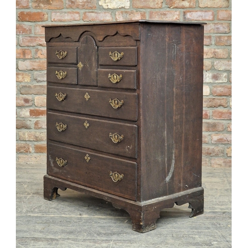 1344 - Georgian oak Norfolk chest of four short over three long drawers, with arched star inlaid cupboard d... 