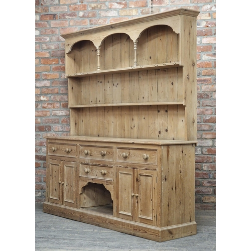 1346 - Large antique stripped pine kitchen dresser fitted with an arrangement of drawers and cupboards, com... 