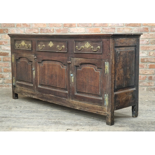 1347 - Georgian oak dresser base fitted with three drawers and three cupboards, brass handles and fielded p... 