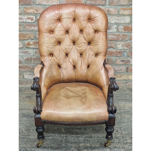 1192 - 19th century Irish leather button back library chair with scrolled arms and studded edging, raised o... 