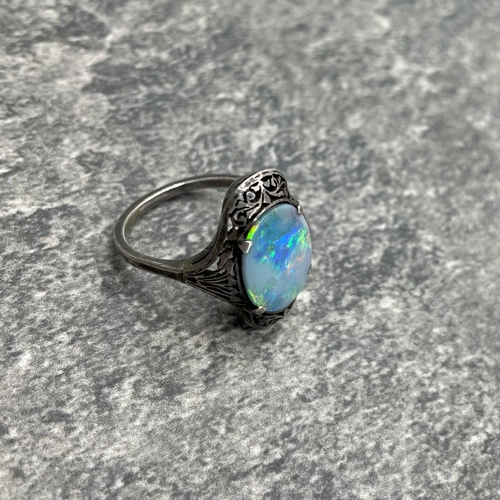 69 - Victorian black opal unmarked white metal ring, the opal set in a pierced mount, size N