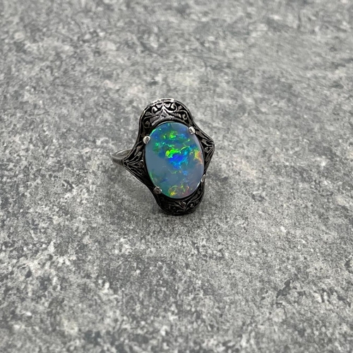 69 - Victorian black opal unmarked white metal ring, the opal set in a pierced mount, size N